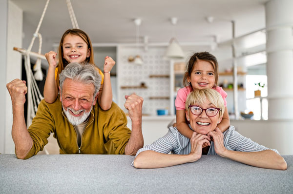 Grandchildren and grandparents having fun together in their kitchen